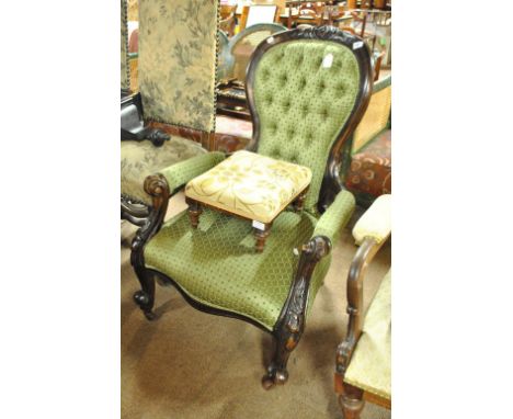 A stained beech lady's button upholstered low easy chair, on carved scrolling front legs and a small stool (2).