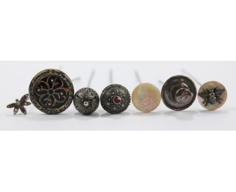 Seven various hat pins to include a tortoiseshell hallmarked silver framed example, London 1911, length 12cm, a hallmarked si