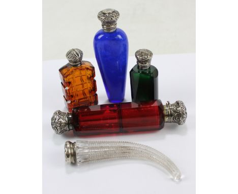 Five late 19th/early 20th century white metal mounted variously coloured glass scent bottles to include a sterling silver cap