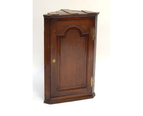 A George III oak flat fronted corner cupboard with fielded panel door, height 90cm.