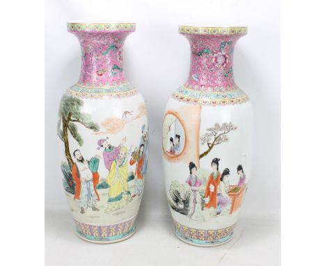 A near pair of modern Chinese porcelain rouleau vases painted in enamels with figural garden scene and with four character se