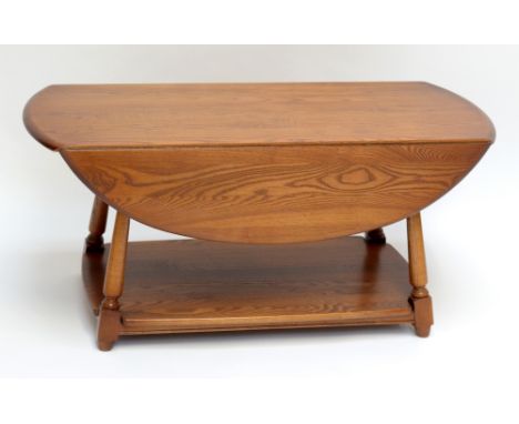 ERCOL; a dropleaf coffee table on splayed legs, width 106.5cm.