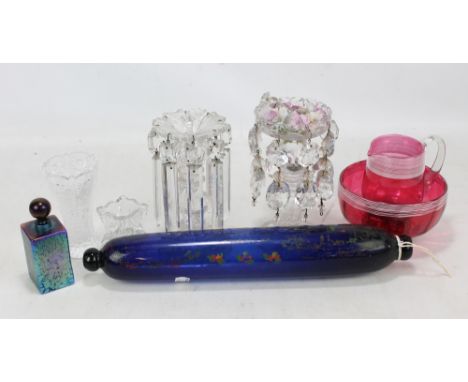 A Victorian cranberry glass jug and bowl with white enamel trail decoration, a glass rolling pin/salt container with indistin