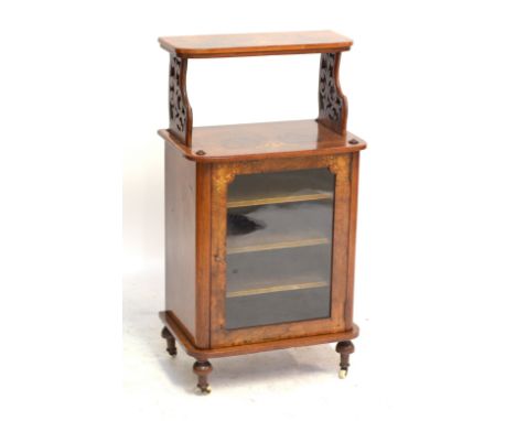 A Victorian figured walnut and marquetry inlaid music cabinet with raised upper shelf and glazed door enclosing three shelves