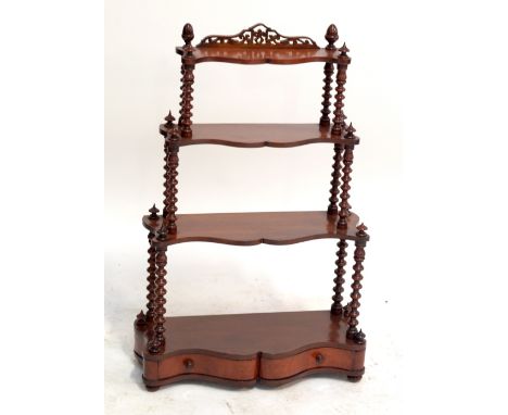 A set of Victorian mahogany graduated hanging wall shelves of serpentine outline with bobbin turned uprights and single drawe