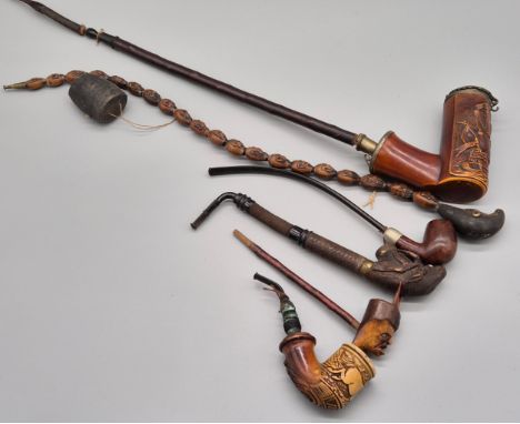 A collection of six antique pipes; Black forest carved stag smoking pipe, devil style head smoking pipe, meerschaum pipe with