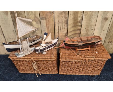 Two vintage wicker hamper baskets containing model boats 