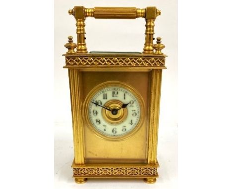 An early 20th century French gilt brass carriage clock, having porcelain dial with Arabic numerals, housing an 8 day movement