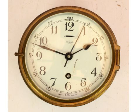 A Tempora brass bulkhead clock, circa early 20th century, made in England, having an 8 day movement, 20cm diameter. 