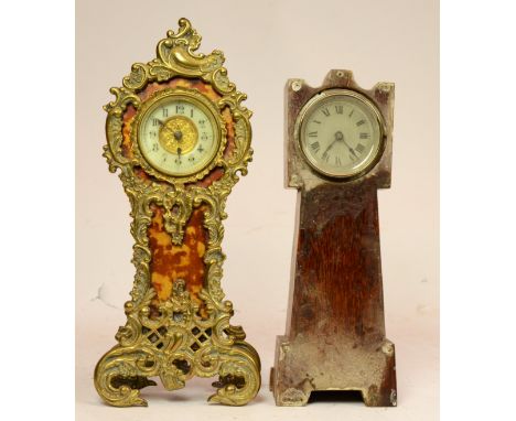 A Rococo style gilt mantel clock, having pierced scrolling foliate with faux tortoise shell casing, housing an English 8 day 