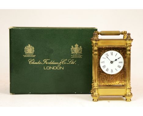 A brass 8 day carriage clock, by Charles Frodsham of London, complete with original box, 13cm tall. 