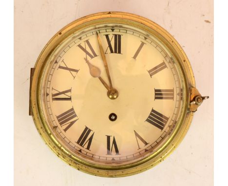 A brass bulkhead clock, with 8 day movement, unnamed, 20cm diameter. 