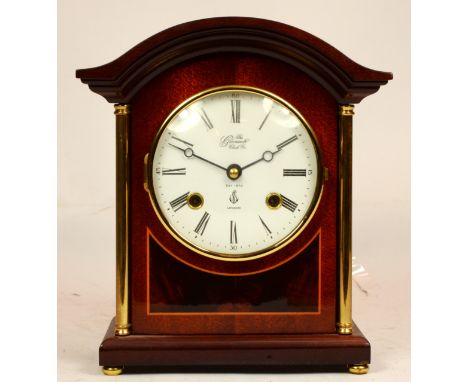 A modern inlaid mahogany mantel clock, having 8 day movement striking on bell, 23cm tall. 