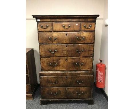 A George II walnut chest on chest, on bracket feet