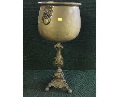 A large brass planter and stand
