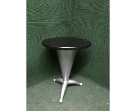 A circular coffee table on metal tripod base 