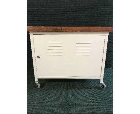 A metal storage trolley with pine top together with a floor lamp