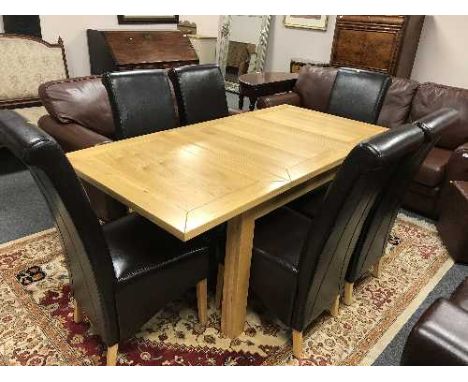 A contemporary light oak extending dining table together with six brown leather chairs