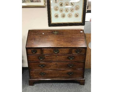 A George III mahogany bureau on bracket feet