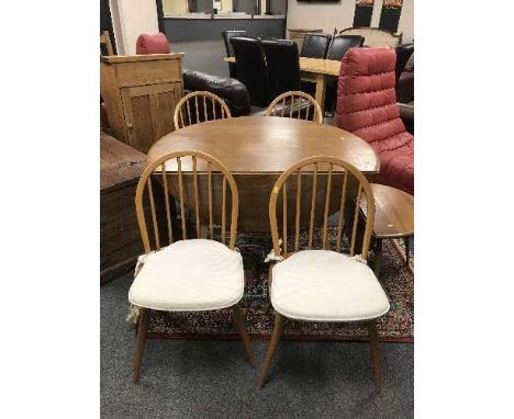 An Ercol light elm flap-sided dining table together with four Windsor chairs