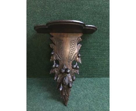 A late 19th century heavily carved mahogany wall bracket 