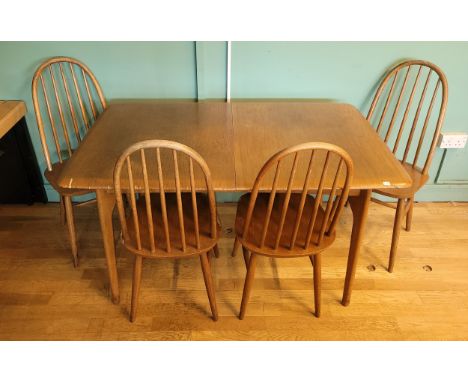A mid 20th century  teak extending dining table, the rectangular top with folding insert leaf, raised on splayed supports, to