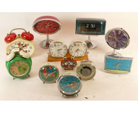 A collection of mid 20th century and later childrens bedside alarm clocks, together with 1970s manual wind 'futuristic' mante