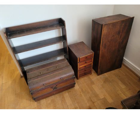 An early 20th century metal traveling trunk, together with an oak open bookshelf unit, a small five drawer chest and a mahoga