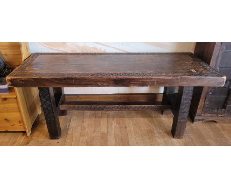 A mid 20th century Eastern padouk hardwood console table, of rectangular form, the top with carved scroll border, raised on s