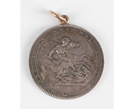 A George III crown 1818 (edge numerals obscured), mounted with a ring and a suspension loop.Buyer’s Premium 29.4% (including 