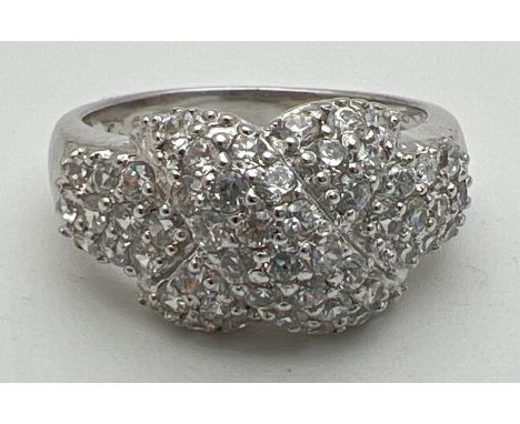 A silver and cubic zirconia multi-stone kiss ring set with 53 small round cut stones. Stamped 925 inside band. Ring size OÂ½.