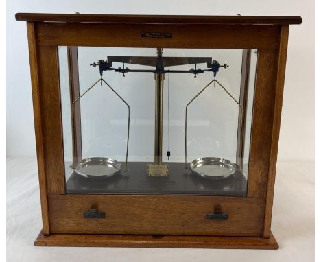 A set of Griffin &amp; george microid chemist scales, in a Philip Harris &amp; Co (1913) glass panelled cabinet. Bakelite bas