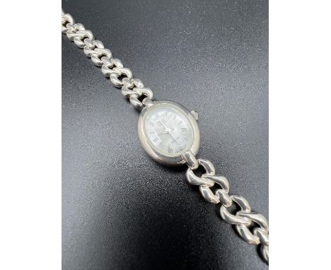 A ladies sterling silver quartz wristwatch by Carvel. Twist design link bracelet strap with extra links. Oval mother of pearl