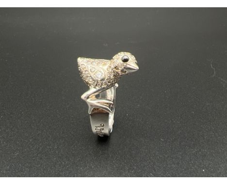 A 925 silver Chick ring by Vivienne Westwood. Silver band with chick to top set with clear and black stones. Designer name to