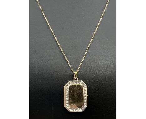 A rectangular shaped 9ct gold locket with small stone mount detail to edges (no stones). On an 18" fine rope chain with sprin