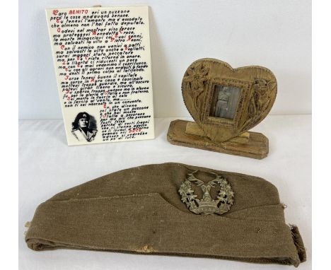 3 items of militaria. A reproduction Mussolini ceramic tile, an army side cap with The Gordon Highlanders cap badge and Highl