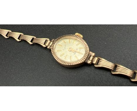 A ladies vintage gold cased 'Everite' Swiss made quartz wrist watch with 9ct gold link bracelet. Inside of case and both part