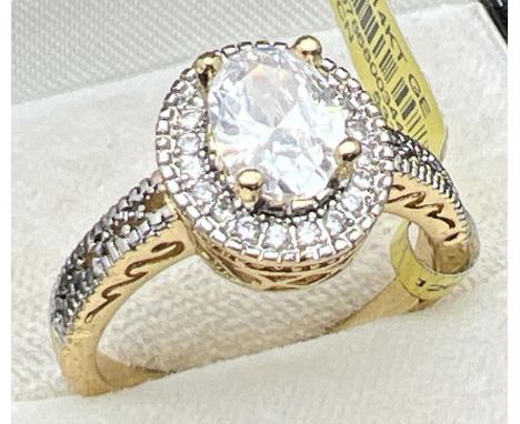 A 14ct gold plated Halo setting cocktail ring set with Swarovski crystals (brand new with tags). Central oval cut stone surro