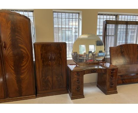 A vintage 1940's walnut veneer 4 piece bedroom suite with shaped handles of channelled design. 2 door double wardrobe with in