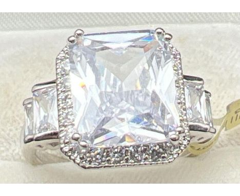 A rhodium plated cocktail ring set with clear Swarovski crystals, new with tags. A large square cut central stone with 2 two 