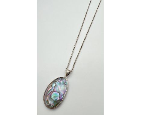 An oval shaped Abalone shell pendant set in silver, on a 20" belcher chain with spring ring clasp. Pendant approx. 5cm long (