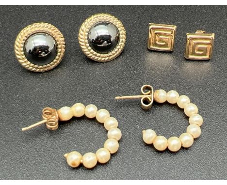 3 pairs of gold and yellow metal earrings. A pair of half hoops with faux pearl beads, a pair of square studs with Greek Key 