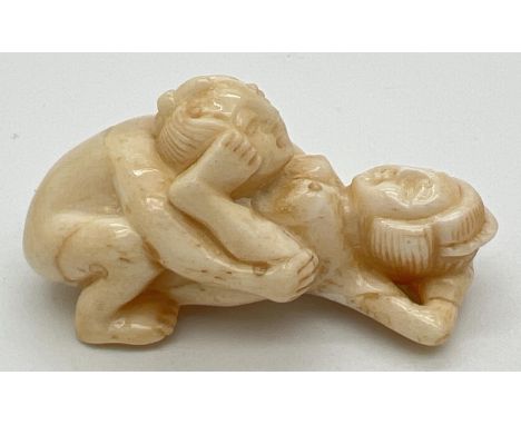 A small carved erotic netsuke with polished finish and signature to underside. Approx. 5cm long. 