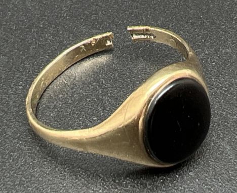 A 9ct gold signet ring set with an oval of black onyx - for scrap or repair. Original size S, cut through. Total weight appro