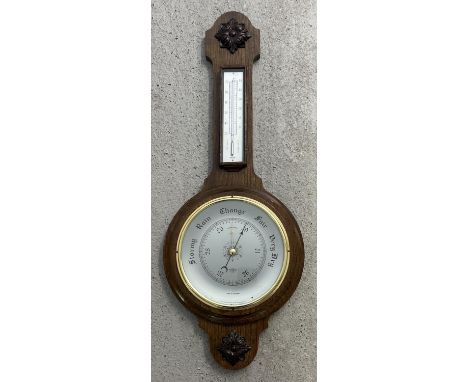 A large vintage dark wood Shortland Smiths banjo barometer with thermometer. Carved applied panels top and bottom. Approx. 76