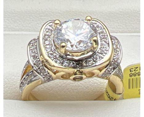 A 14kt gold plated Swarovski crystal set cocktail ring, new with tags. Decorative high shoulder and mount ring with multiple 