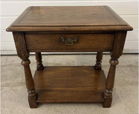 A vintage dark oak Simon Simpson, Norwich (Mark Chambers) side/occasional table with central drawer and turned legs. Makers m