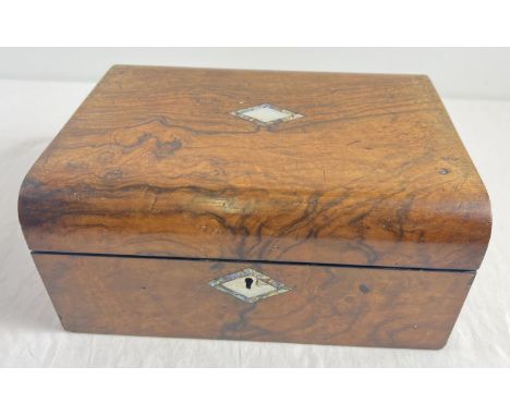 An antique wooden writing box (interior slope and compartments missing) with brass lock and hinges. Mother of pearl diamond s
