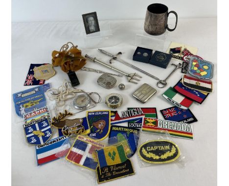 A small collection of vintage misc items. To include cloth badges depicting world countries, a nickel plated sovereign case, 