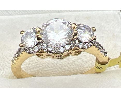 A 14ct gold plated cocktail trilogy ring set with Swarovski crystals, new with tags. 3 round cut stones surrounded by smaller